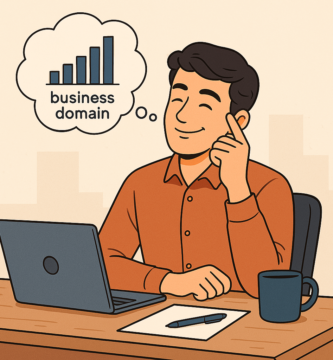 Illustration of a young man sitting at a desk with a laptop, smiling and thinking about business domain strategy, represented by a thought bubble containing a bar chart labeled 'business domain